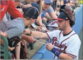  ?? File - Jeremy Stewart ?? Dansby Swanson signs autographs for fans before a rehab assignment with the Rome Braves in May 2018. The Atlanta infielder will return to Rome on Thursday as he overcomes a foot injury.