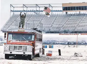  ??  ?? One fan braves the elements as snow covers the infield at Atlanta Motor Speedway after a winter storm in March 1993. PHIL CAVALI