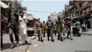  ??  ?? Army troops patrol on a street in Lahore to implement COVID rules