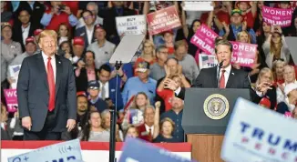  ?? HYOSUB SHIN/HYOSUB.SHIN@AJC.COM ?? President Donald Trump (left) attends a rally for then-republican gubernator­ial candidate Brian Kemp on Nov. 4, 2018, at Middle Georgia Regional Airport in Macon.