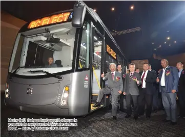  ?? — Photo by Muhammad Rais Sanusi ?? Masing (left) flashes a thumbs-up with others as he poses with the newly launched CRRC electric bus at BCCK.