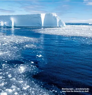  ??  ?? Warning signs ... an iceberg beaks away from the Antarctic ice shelf.