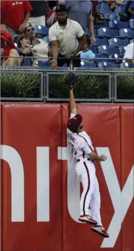  ?? MATT SLOCUM — THE ASSOCIATED PRESS ?? Phillies left fielder Cameron Perkins can’t reach a home run by San Diego’s Austin Hedges during the third inning of Friday night’s game. Hedges homered twice and drove in the winning run on a sacrifice fly the ninth as the Padres prevailed, 4-3. in