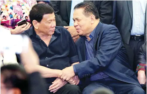  ??  ?? DAVAO ENCOUNTER – President Duterte chats with Moro Islamic Liberation Front Chairman Al Hajj Murad Ebrahim (right) following the celebratio­n of Eid’l Fitr at the SMX Convention Center in Davao City Saturday. The President assured MILF and other Muslim leaders the Bangsamoro Basic Law will be signed into law. (Keith Bacongco)