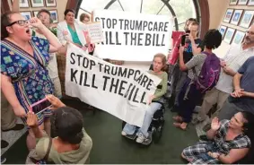  ??  ?? Protesters unhappy with the Republican health care bill gather inside the Capitol Hill office of Sen. Rob Portman, R- Ohio, on Monday.
| MANUEL BALCE CENETA/ AP