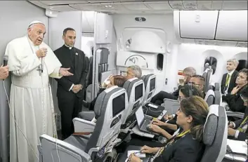  ?? Andrew Medichini/Associated Press ?? Pope Francis talks to journalist­s during a news conference aboard a flight to Rome on Monday at the end of a five-day visit to Colombia.