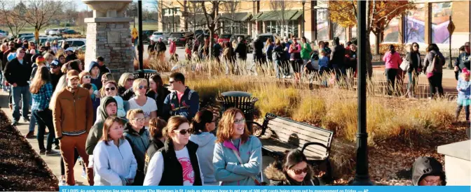  ??  ?? ST LOUIS: An early morning line snakes around The Meadows in St. Louis as shoppers hope to get one of 500 gift cards being given out by management on Friday. — AP