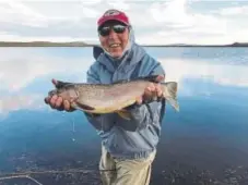  ?? Courtesy of Dave Justus ?? Frank Cada shows off a monster Rainbow Trout caught in North Delaney Butte Lake near Walden.