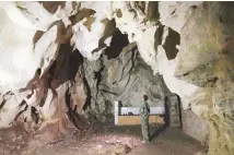  ??  ?? A man stands inside the abandoned Wanling cave near Manhaguo village in southern China’s Yunnan province. (AP)