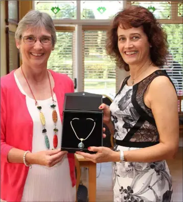 ??  ?? New Ross lady Captain Mary Maher (right) presenting her prize to Ann Banville.