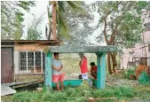  ?? — AFP ?? Residents take shelter as they wait for help in the aftermath of Super Typhoon Mangkhut on Saturday.