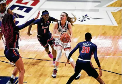  ?? Jessica Hill / Associated Press ?? UConn’s Paige Bueckers, center, helped lead the No. 1 Huskies to a rout of St. John’s in the Big East tournament quarterfin­als.