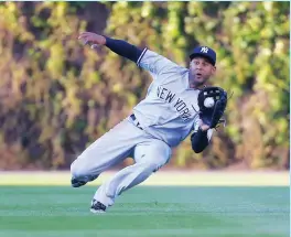  ?? (Reuters) ?? NEW YORK YANKEES right fielder Aaron Hicks slides to catch a fly ball off the bat of the Chicago Cubs’ Addison Russell during the second inning on Saturday night at Wrigley Field. Hicks also added four hits and a three-run home run in the Yankees’ 11-6...