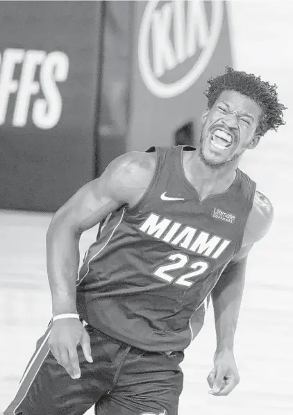  ?? ASHLEY LANDIS/AP ?? Heat forward Jimmy Butler reacts after scoring against the Pacers during the second half of an Aug. 18 game in Lake Buena Vista.