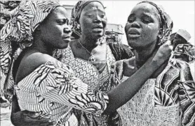  ?? OLAMIKAN GBEMIGA/AP ?? Relatives embrace one of the girls released by Boko Haram on Saturday in Abuja, Nigeria.