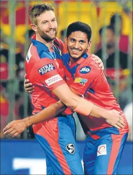  ?? PTI ?? Gujarat Lions pacers Andrew Tye (left) and Basil Thampi shared four wickets to break the back of struggling Royal Challenger­s Bangalore’s famed batting lineup in Bangalore on Thursday.