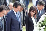  ?? ASSOCIATED PRESS ?? Japanese Prime Minister Shinzo Abe (second from left) bows at the Ehime Maru Memorial Monday in Honolulu. The memorial is dedicated to victims of a 2001 seafaring collision.