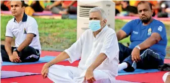  ?? ?? CHILLING OUT: Prime Minister with some of the Cabinet members going through the Yoga motions at Independen­ce Square on World Yoga Day on Tuesday
