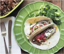  ?? THE ASSOCIATED PRESS ?? Barbacoa beef tacos, from a recipe by Katie Workman, are extremely flavourful and tender.