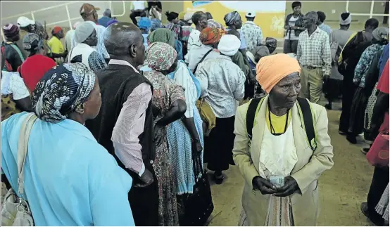  ??  ?? A pensioner leaves the pay point after receiving her grant at Schoemansd­al Community Hall near Malelane, Mpumalanga, yesterday.