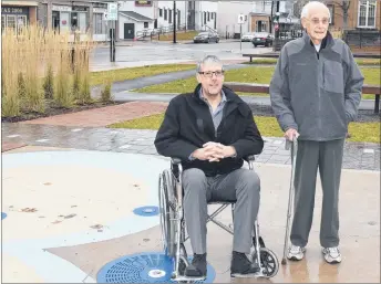  ?? ADAM MACINNIS/THE NEWS ?? Stellarton Mayor Danny MacGillivr­ay looked at some areas around the downtown with local resident George Rae, who at 93 enjoys walking the area.