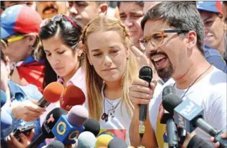  ?? FEDERICO PARRA/AFP ?? Lilian Tintori (centre), wife of recently released Venezuelan political prisoner and opposition leader Leopoldo Lopez, listens to the vice president of the National Assembly, Freddy Guevara, delivering a speech during a demonstrat­ion marking 100 days...