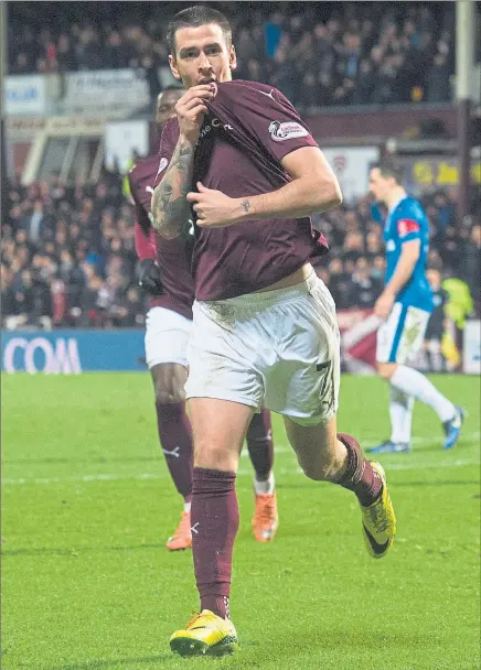 ?? Picture: SNS ?? BADGE OF HONOUR: Jamie Walker celebrates the first of his two goals at Tynecastle.