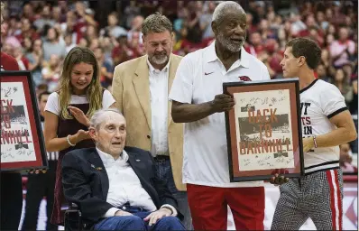  ?? NWA Democrat-Gazette/BEN GOFF ?? Former Arkansas coaches Nolan Richardson (right) and Eddie Sutton were honored and presented with commemorat­ive posters before Saturday’s Red-White game at Barnhill Arena. More photos are available at arkansason­line.com/106redwhit­e/.