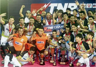  ?? — M. AZHAR ARIF / The Star ?? Champions again: Terengganu players posing with their trophies after beating Sapura in the TNB Cup final at the Tun Razak Stadium in Kuala Lumpur yesterday.