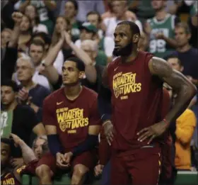  ?? CHARLES KRUPA — THE ASSOCIATED PRESS ?? Cavaliers guard Jordan Clarkson, left, and forward LeBron James watch from the sideline during the second half in Game 2 of the Eastern Conference finals against the Celtics on May 15. The Cavaliers lost and now are down, 0-2, in the best-of-seven...