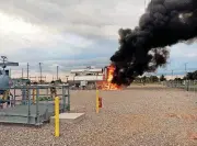  ?? PROVIDED BY THE OKLAHOMA CITY FIRE DEPARTMENT] [PHOTO ?? This photograph shows the fire burning at a tank associated with a line supplying natural gas to an Oklahoma Gas &amp; Electric Co. power plant in west Oklahoma City.