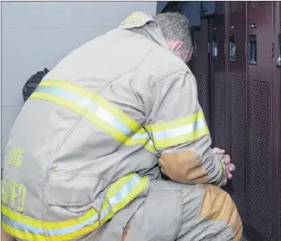  ?? JOE GIBBONS/THE TELEGRAM ?? A St. John’s firefighte­r collects his thoughts after a tough day at work. This firefighte­r has a new ally in dealing with stressful situations with the implementa­tion of the Road to Mental Readiness program in November.