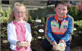  ??  ?? Sophie and Alex Hickey holding their ‘Kindness Rocks’ in the Flower Garden in Knocknagre­e Fairfield.
Photo by Sheila Fitzgerald.