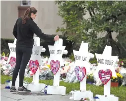  ?? (Reuters) ?? A WOMAN approaches a makeshift memorial for the murdered in Pittsburgh.