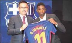  ?? AFP ?? Ousmane Dembele (right) poses with a Barcelona shirt next to Barca president Josep Maria Bartomeu at the Camp Nou during the forward’s presentati­on to the Catalan club on August 28.