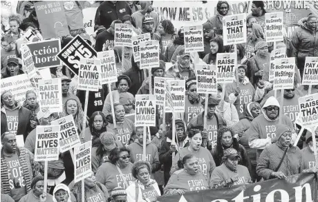  ?? Antonio Perez / Chicago Tribune ?? Activists and workers converge Wednesday near the McDonald’s corporate campus during a wage demonstrat­ion in Oak Brook, Ill.