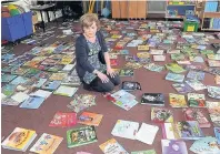  ??  ?? FLOORED Antoinette Devlin tries to salvage sodden books