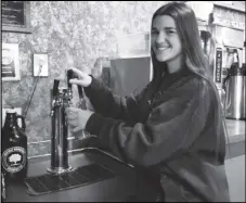  ?? ALICE MANNETTE/THE HUTCHINSON NEWS VIA AP ?? Caeli Clennan serves Inspirit Kombucha Brewing Co.’s Cranberry Orange Kombucha from a kegorator at Metropolit­an Coffee in Hutchinson.