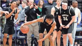  ?? MAX GERSH/THE COMMERCIAL APPEAL ?? Houston’s Alden Applewhite (2) dribbles the ball in front of his bench as the game clock runs out Monday during a Class AAA sectional game against Arlington.