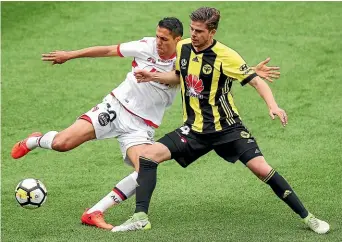  ?? GETTY IMAGES ?? Midfielder Alex Rufer, right, has re-signed with the Wellington Phoenix for another season.