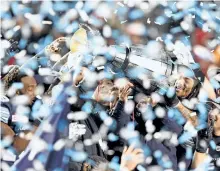  ?? THE CANADIAN PRESS FILES ?? The Toronto Argonauts celebrate as they hoist the Grey Cup after defeating the Calgary Stampeders in the 105th Grey Cup last month. Maple Leaf Sports & Entertainm­ent has struck a deal to buy the Argonauts.