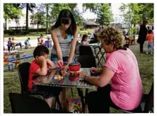  ??  ?? Violette Buchon, ludothécai­re, explique les règles d’un des jeux de société à Brigitte Le Martelot et son fils, deux habitués du parc.