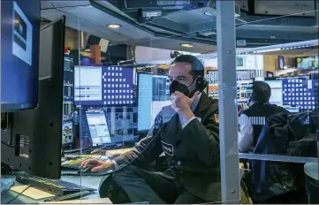  ?? COURTNEY CROW — NEW YORK STOCK EXCHANGE VIA AP ?? Traders work on the New York Stock Exchange floor, Monday as stocks rose across the board on Wall Street.