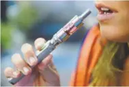  ?? Denver Post file ?? A study at Dartmouth College warns that the high level of nicotine in e-cigs — which vaporize flavored liquids containing the addictive substance — and the expense of the modern habit are setting teens up to become real smokers.
