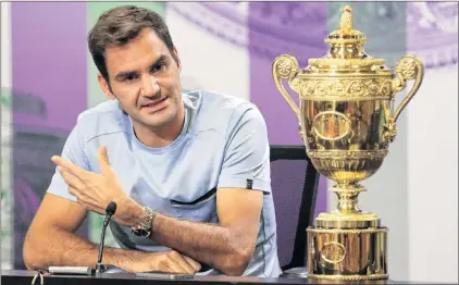  ?? AP PHOTO ?? Roger Federer speaks next to the men’s singles tennis trophy he won on Sunday during a photo call at The All England Lawn Tennis and Croquet Club in Wimbledon, England, on Monday.