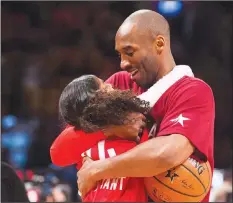  ?? Associated Press ?? Death of a legend: In this Feb. 14, 2016, file photo, Los Angeles Lakers Kobe Bryant (24) hugs his daughter Gianna on the court in warmups before the NBA All-Star Game in Toronto. Bryant, his 13-year-old daughter, Gianna, and several others are dead after their helicopter went down in Southern California on Sunday.