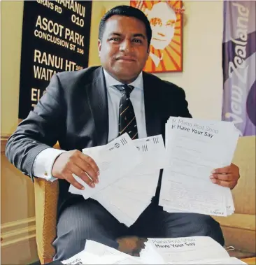  ??  ?? Feedback: Mana MP Kris Faafoi with some of the hundreds of returned surveys on the subject of Mana PostShop.