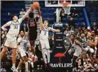  ?? Jessica Hill / Associated Press ?? UConn center Donovan Clingan (32) blocks a shot by Delaware State guard Ricky Deadwyler III (25) as UConn guard Joey Calcaterra (3) defends during the first half of an NCAA college basketball game Sunday in Hartford.