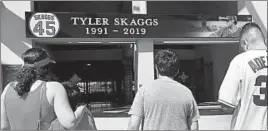  ?? ALEX GALLARDO/AP ?? Fans gather at Angel Stadium to pay respects to Tyler Skaggs, found dead Monday.