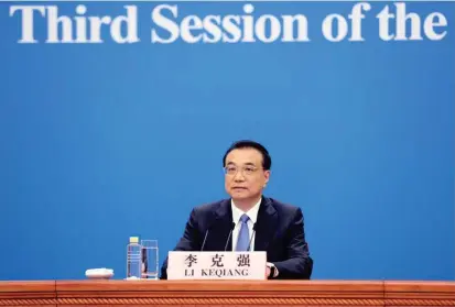  ??  ?? Chinese Premier Li Keqiang answers media questions by video after the end of the third session of the 13th National People’s Congress at the Great Hall of the People in Beijing yesterday. — Xinhua